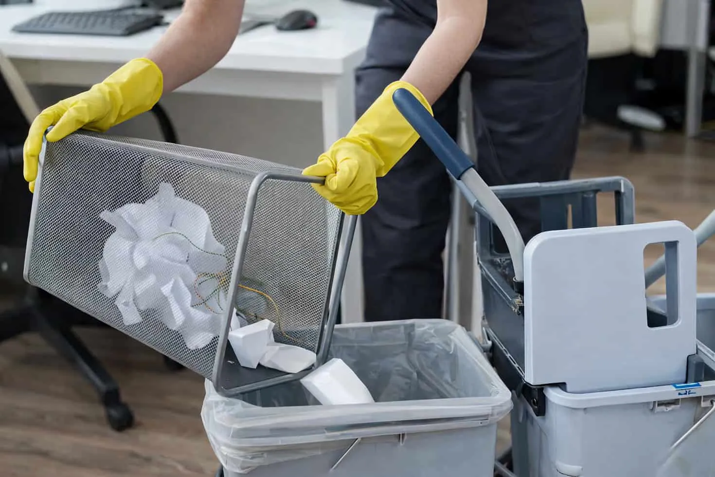 Window cleaning with squeegee and cleaning tools in an office setting.