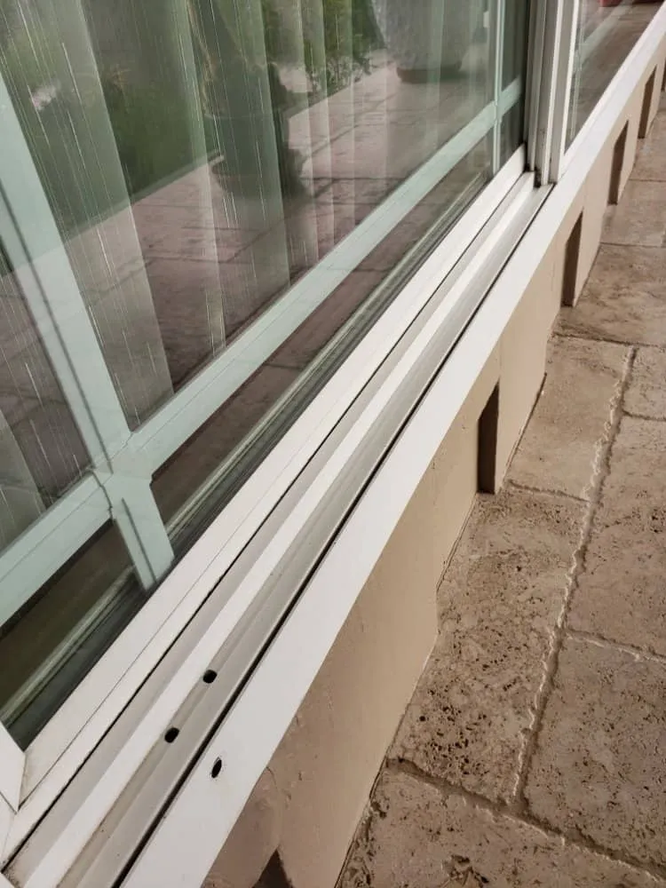 Clean window glass and white frame on house exterior.